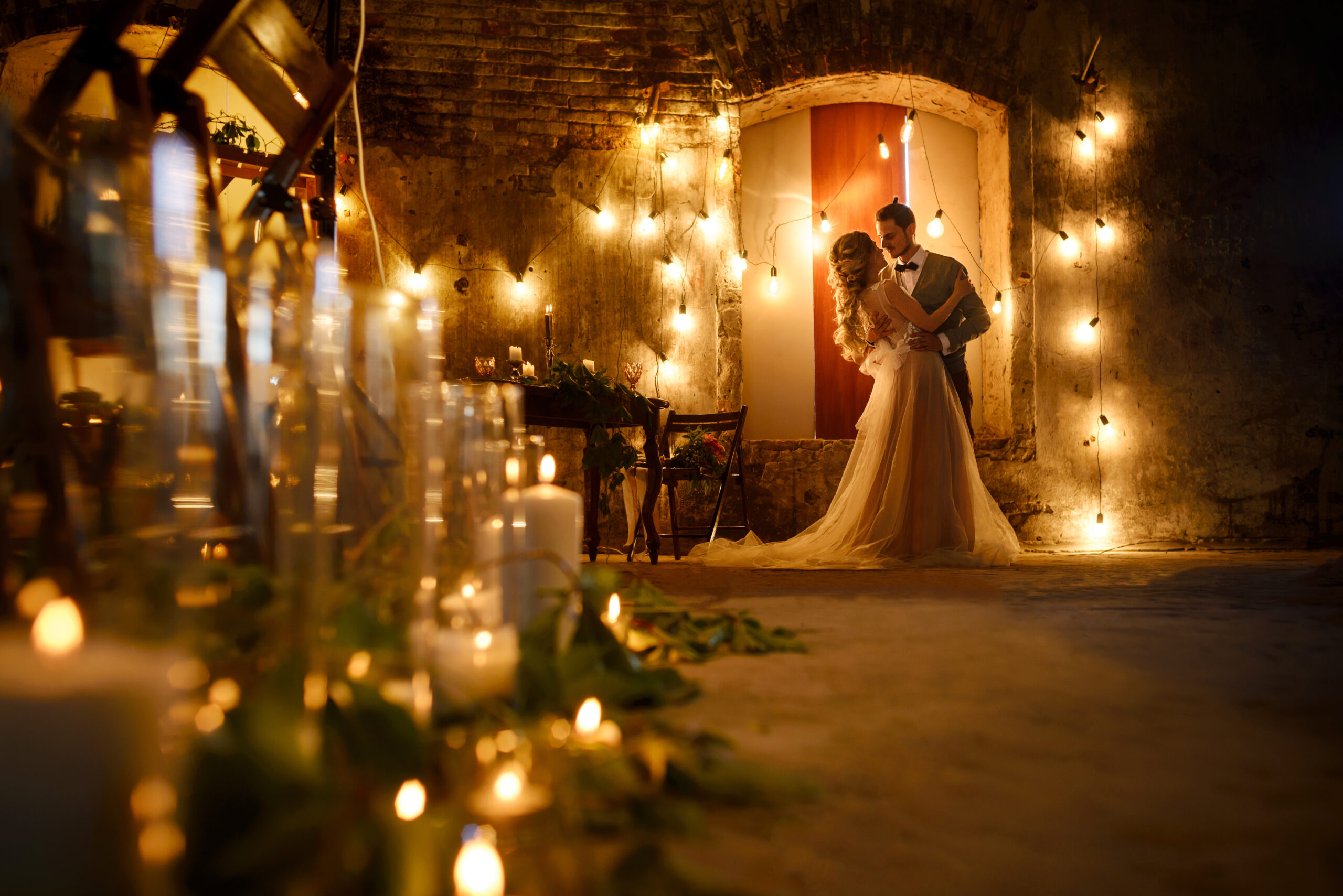 Stylish hipster wedding couple in romantic loft decorations at night